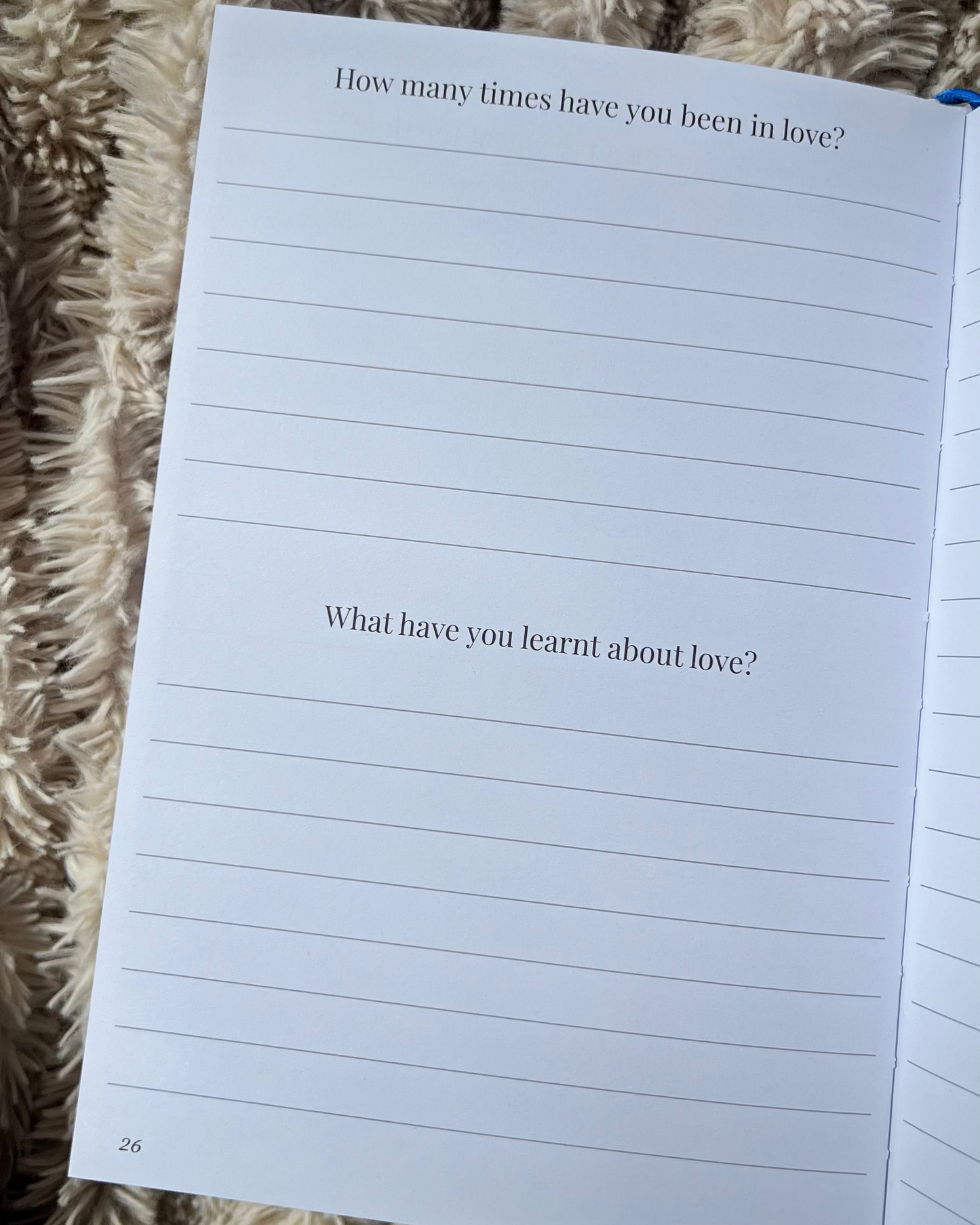 Open book with lined pages on a textured surface